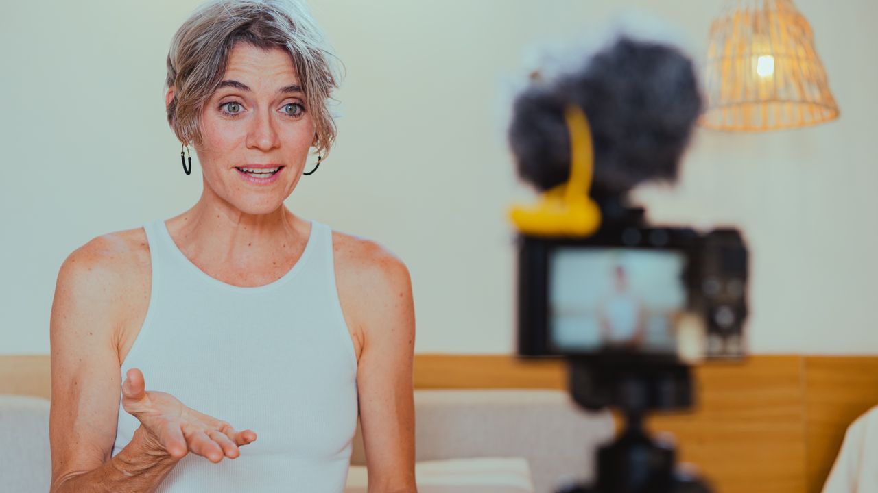 A coach recording a lesson to camera in her own study