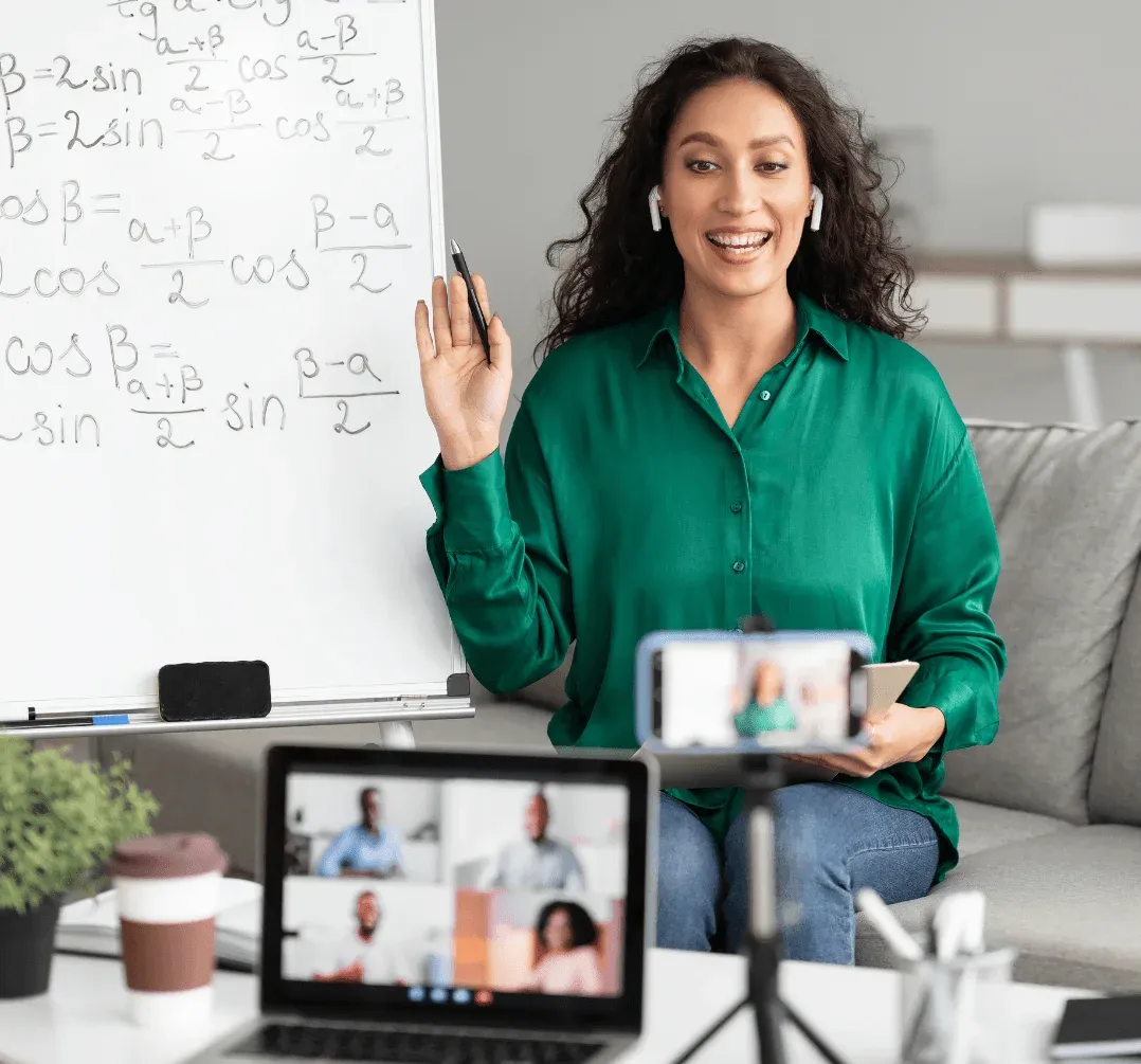 A smiling woman recording a video lesson on her smartphone