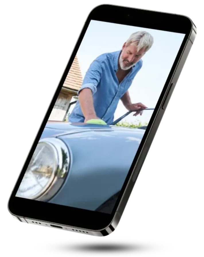A video playing on a phone of a man polishing his classic car