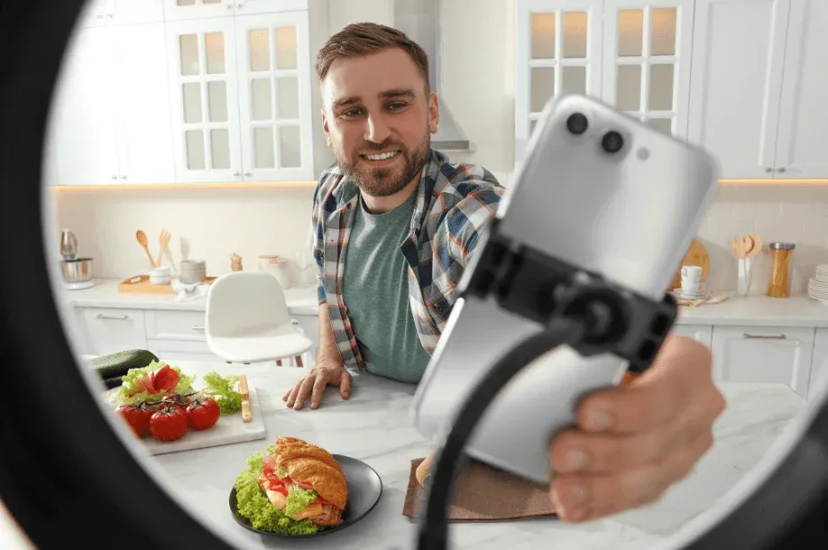 A man filming with a smartphone held on a gimbal